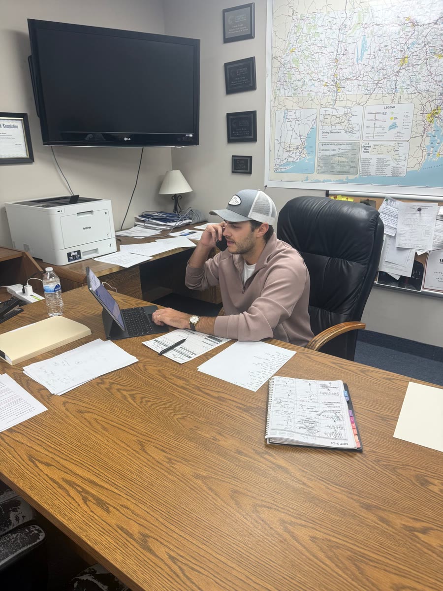 An Acorn Pro Painting team member on a phone call at his desk in the office
