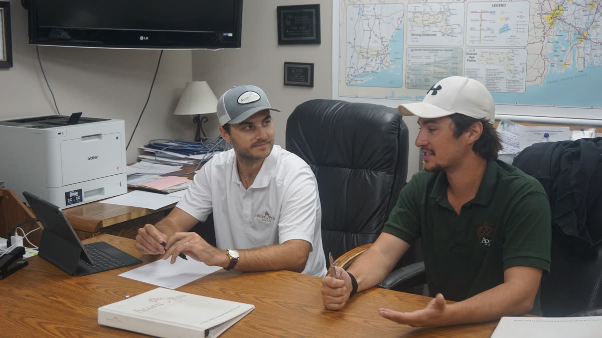 Two Acorn Pro Painting team members talking through a project