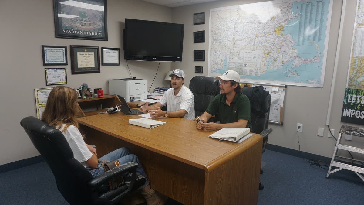 Acorn Pro Painting team members meeting at a desk in the office